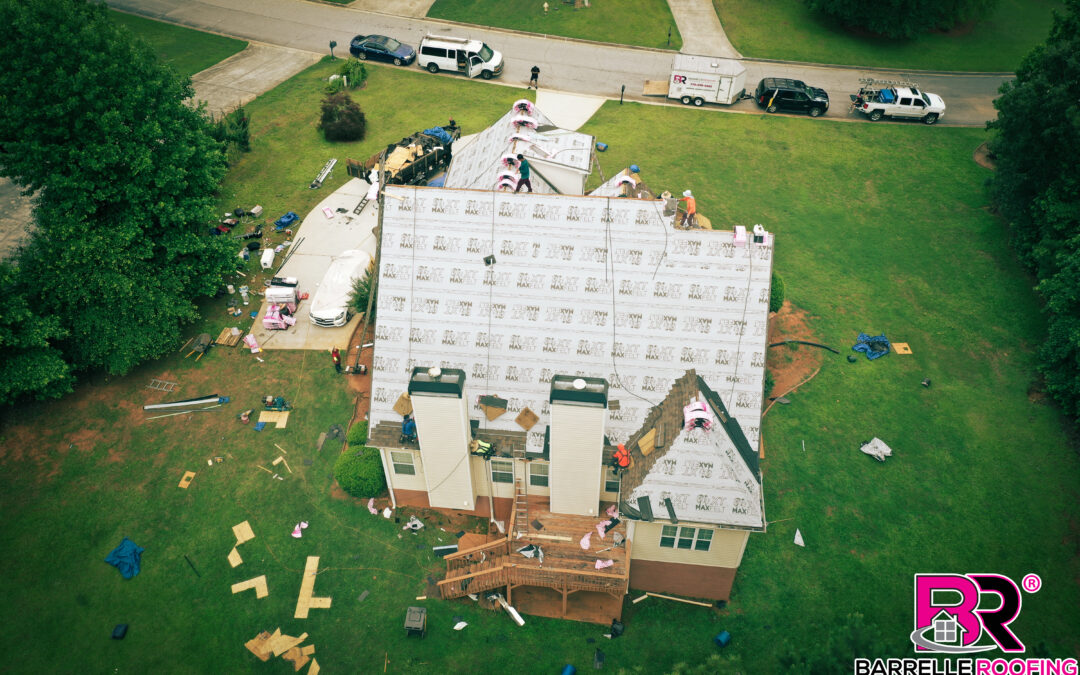 A drone looks down as a new roof is being installed