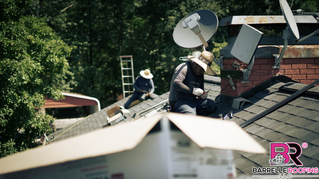 Men in straw sunhats finish installing a new roof.