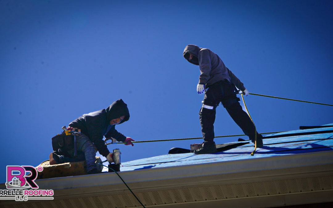 two roofers on roof working