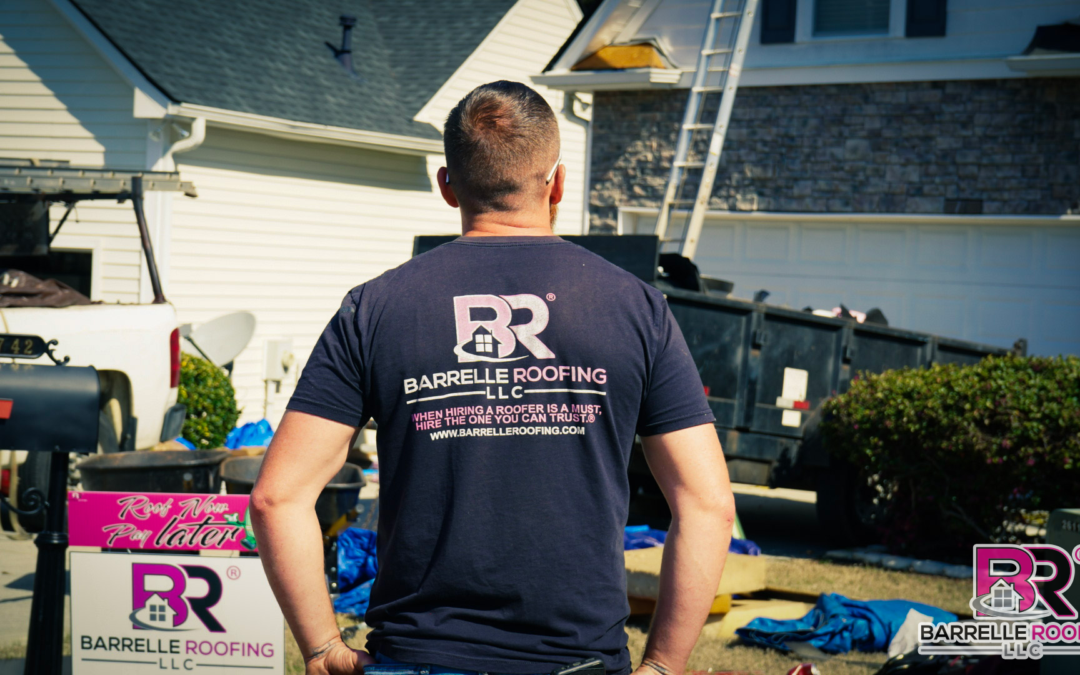 roofer looking at roofing worksite with Barrelle roofing shirt