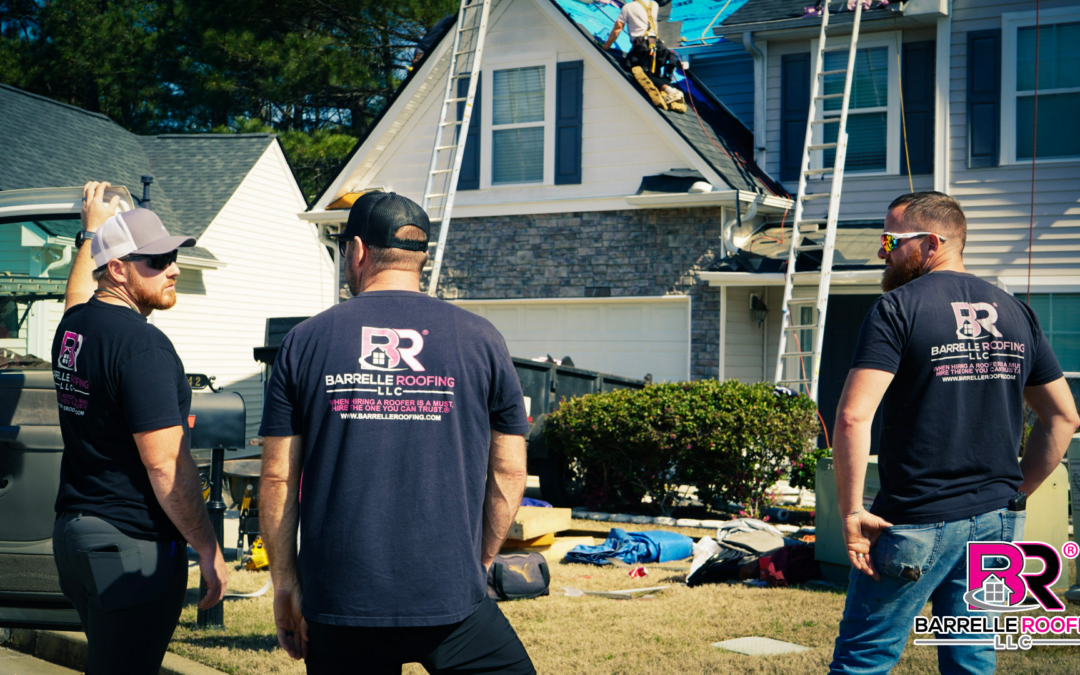 roofers talking with each other at worksite wearing Barrelle Roofing shirts
